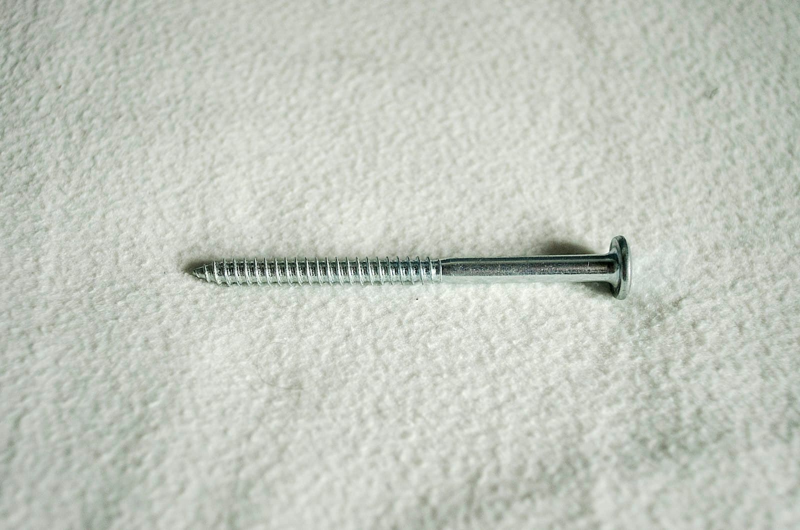 A wood screw on a white surface